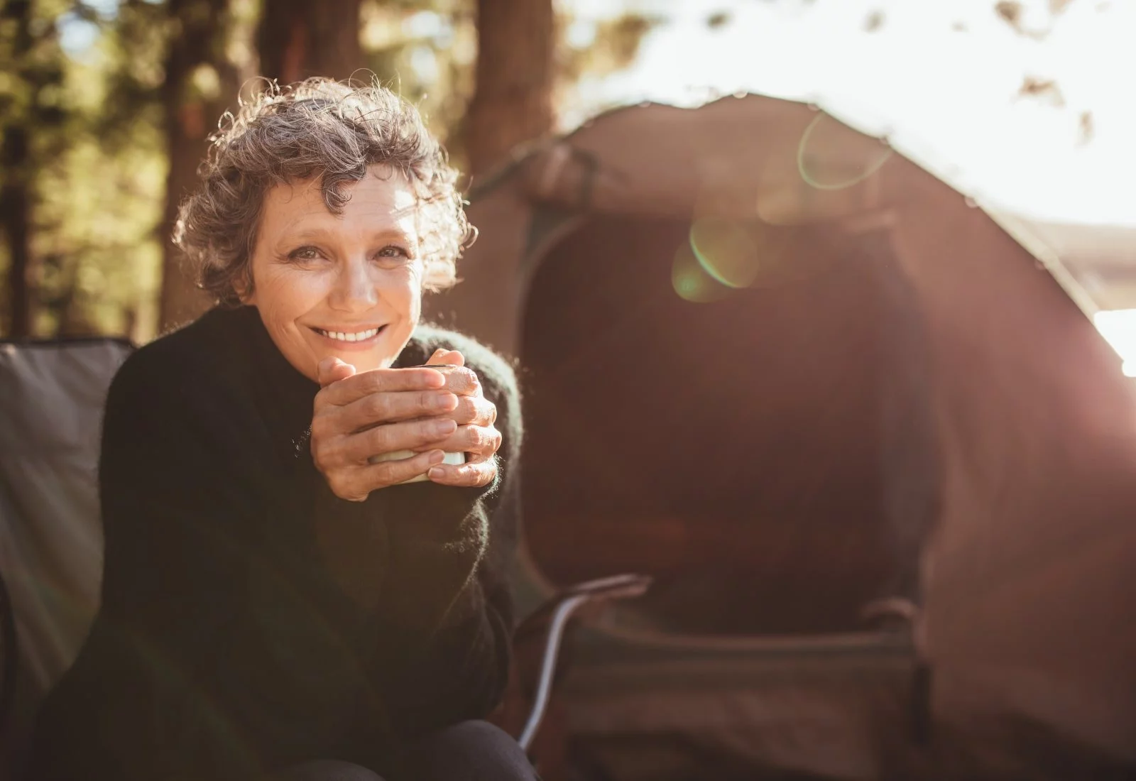 happy mature woman camping, lens replacement brisbane