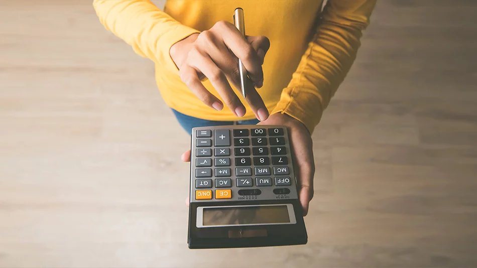 A woman uses a calculator to calculate the cost of SmartSight and LASIK